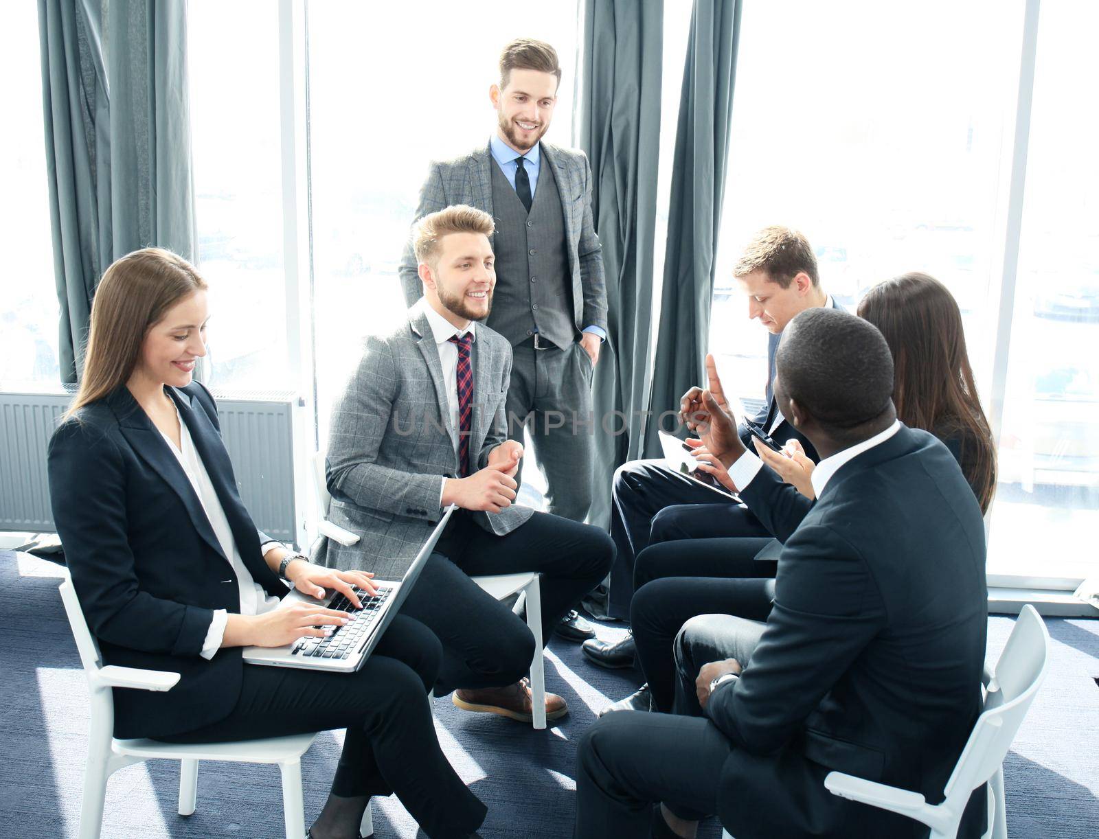 Business team discussing together business plans in office