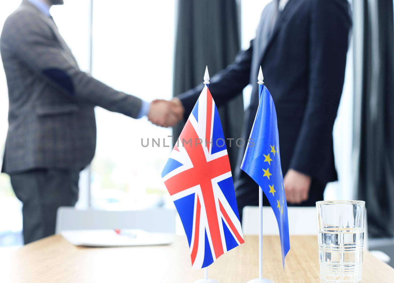European Union and United Kingdom leaders shaking hands on a deal agreement. Brexit by tsyhun