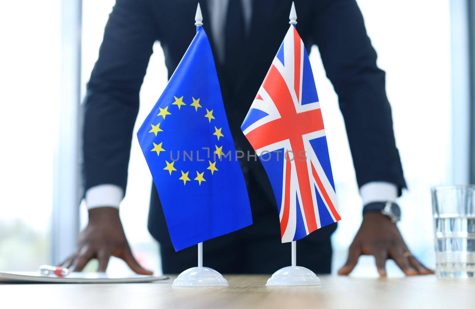 British flag and flag of European Union with businessman near by. Brexit