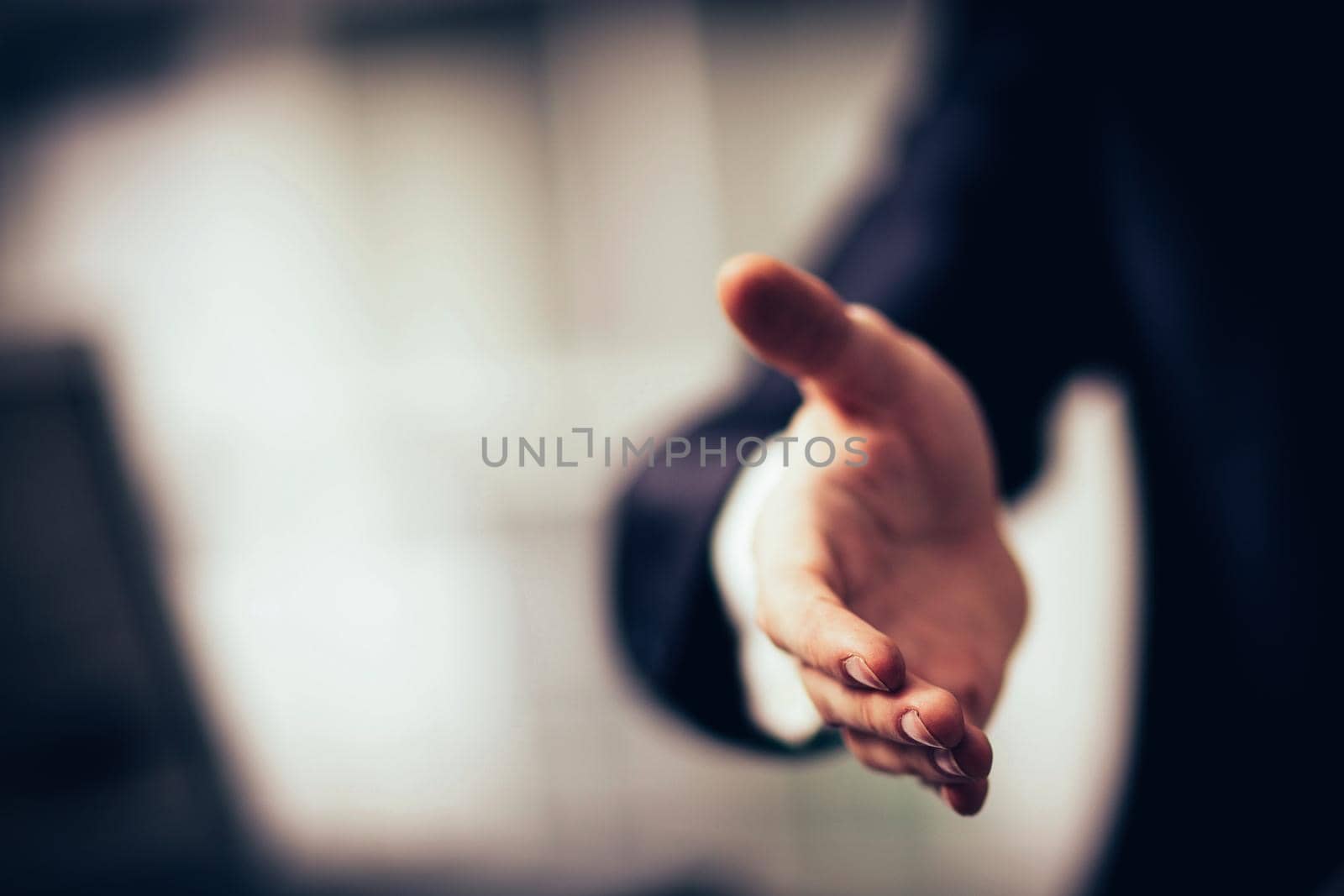 Portrait of successful businesswoman giving hand for the transaction is ready to cooperate
