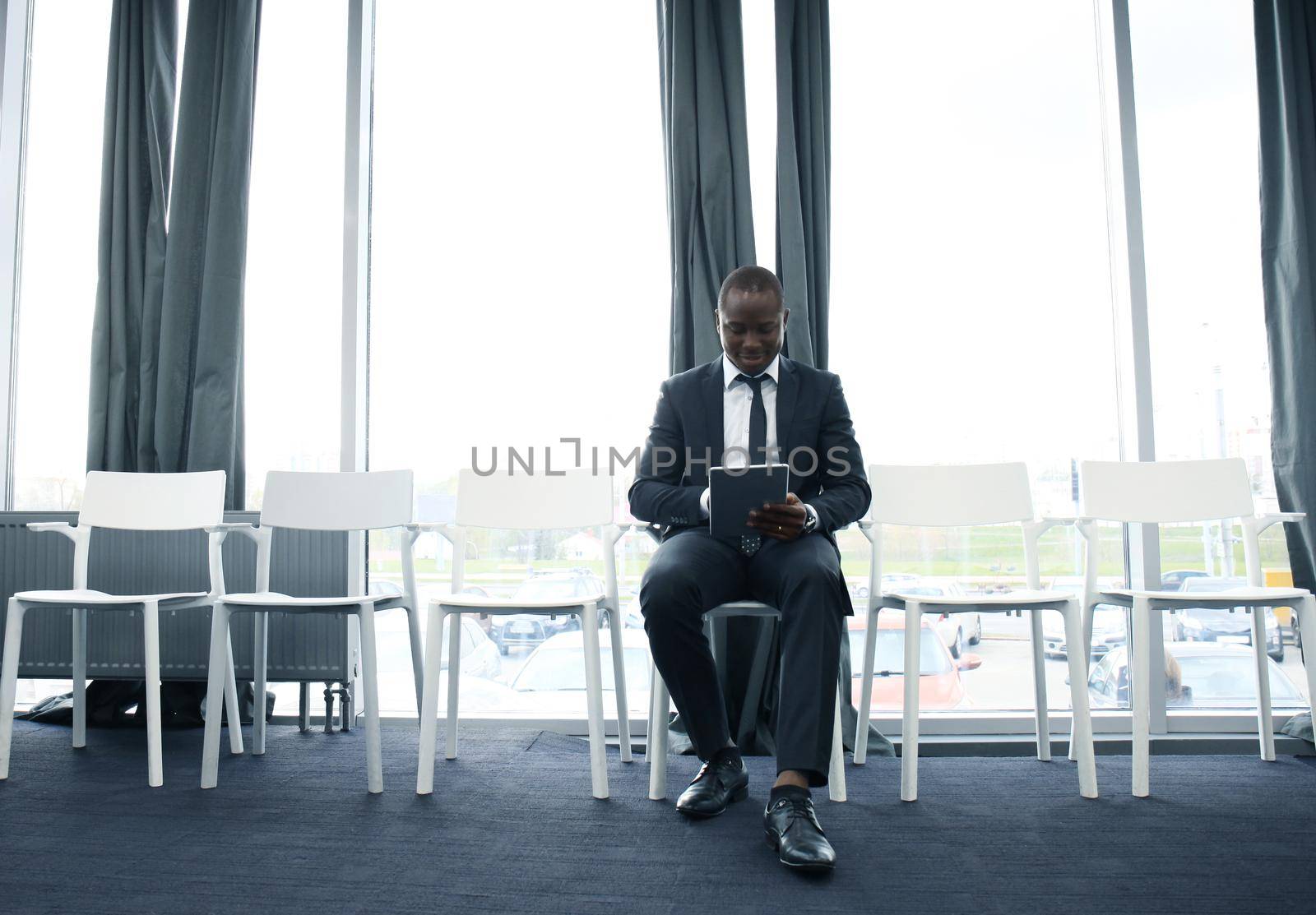 Young man waiting for job interview indoors.