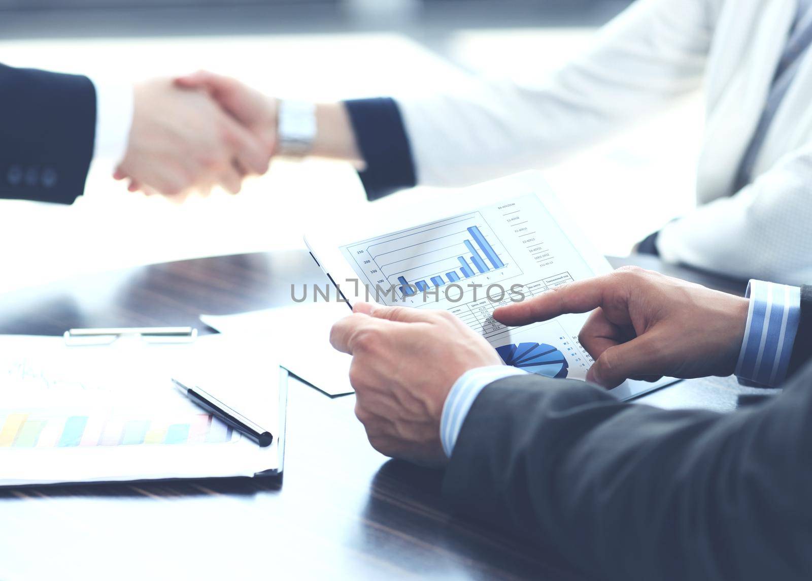 businessman hands touching digital tablet empty screen copy space, handshake during meeting. by tsyhun