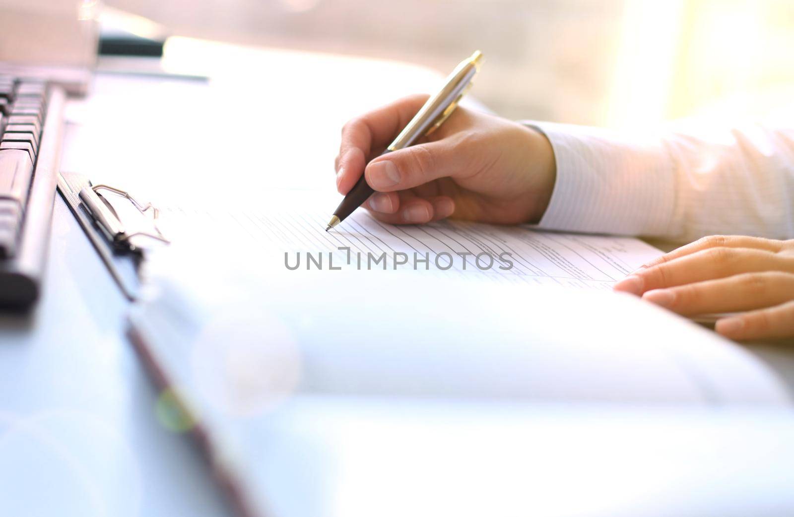 Businesswoman hands pointing at business document