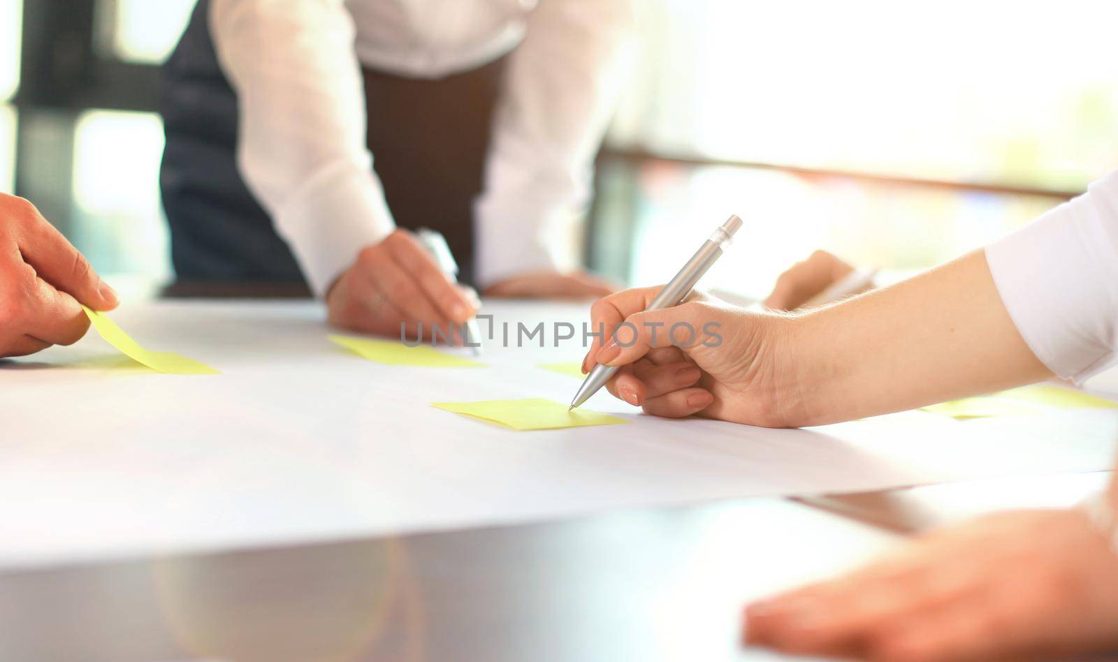 Image of business people hands working with papers at meeting by tsyhun