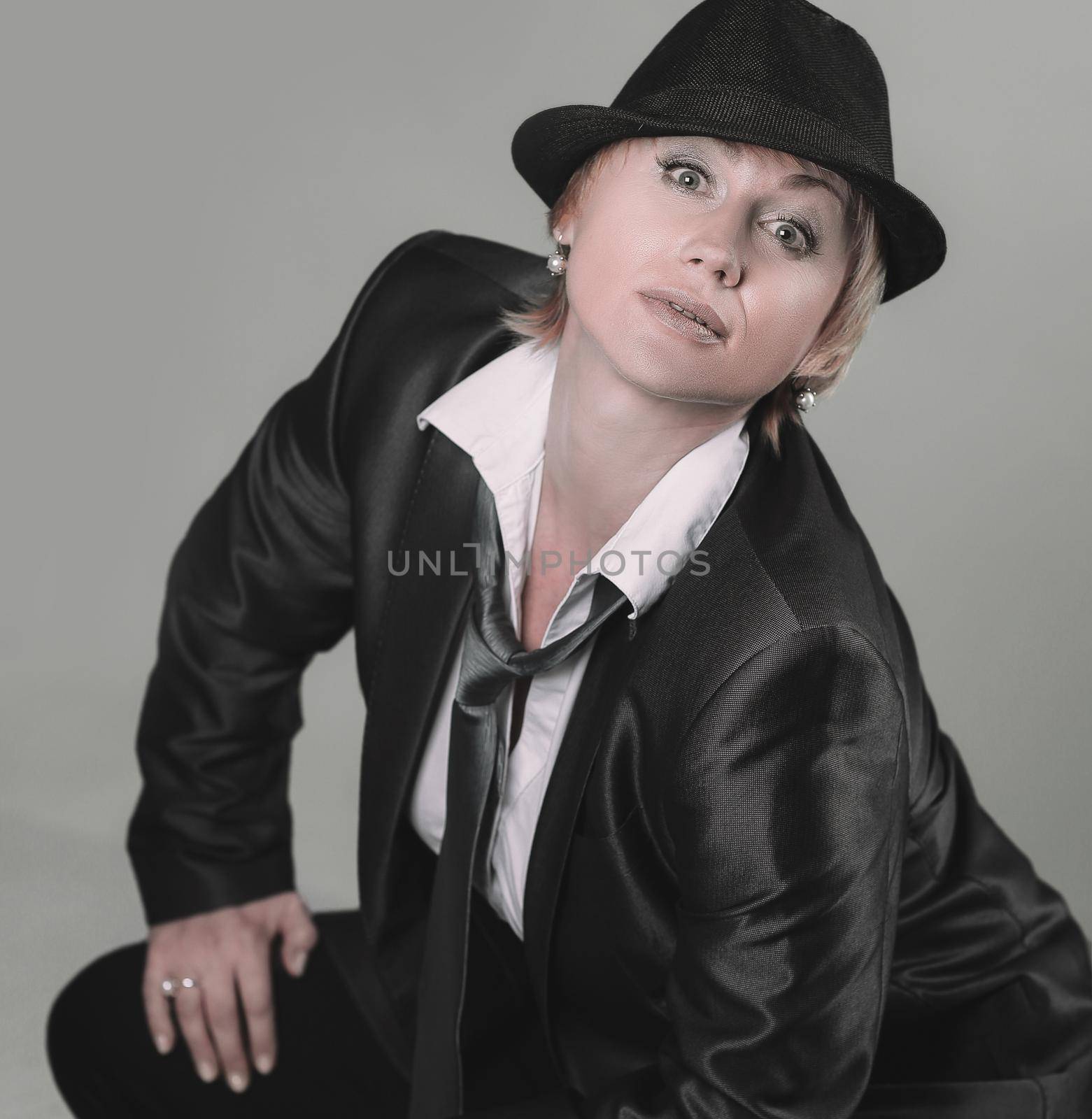 glamorous woman in a pantsuit .isolated on gray background.photo with copy space