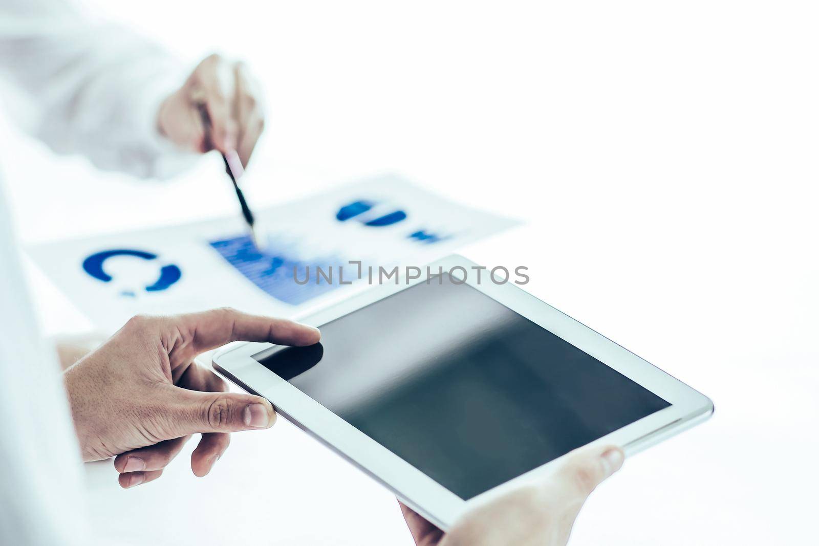 closeup of business team using digital tablet,the report analyzes the marketing behind a Desk in the office