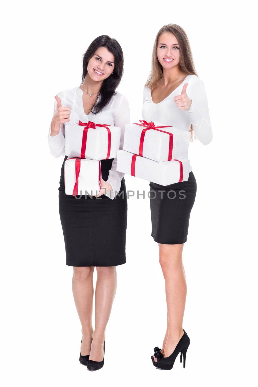 two young women with gift boxes showing thumbs up. isolated on white background