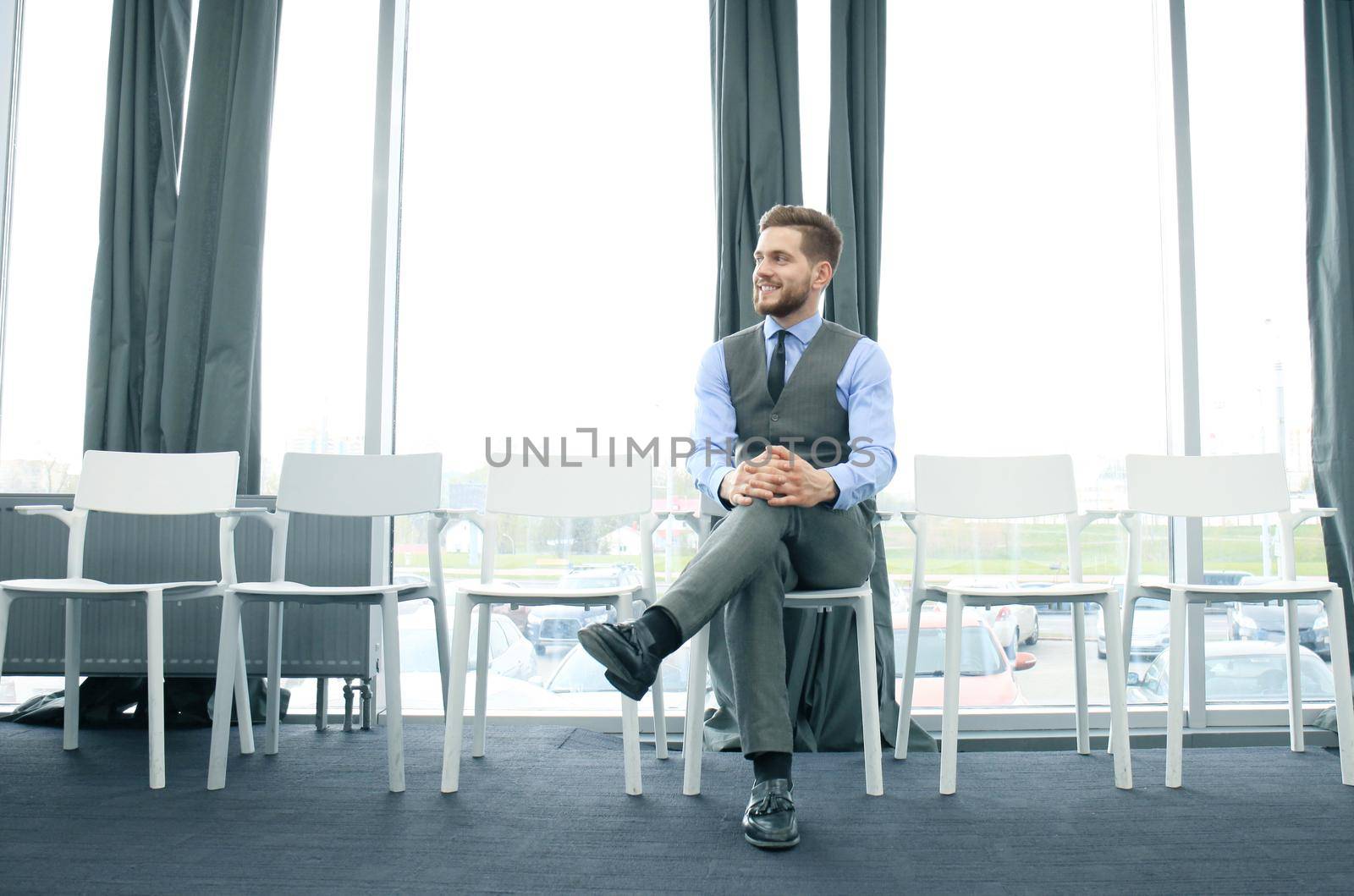 Young man waiting for job interview indoors.