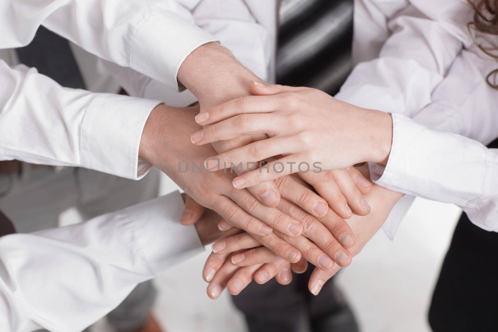 closeup .the hands of the members of the business team put together.the concept of teamwork