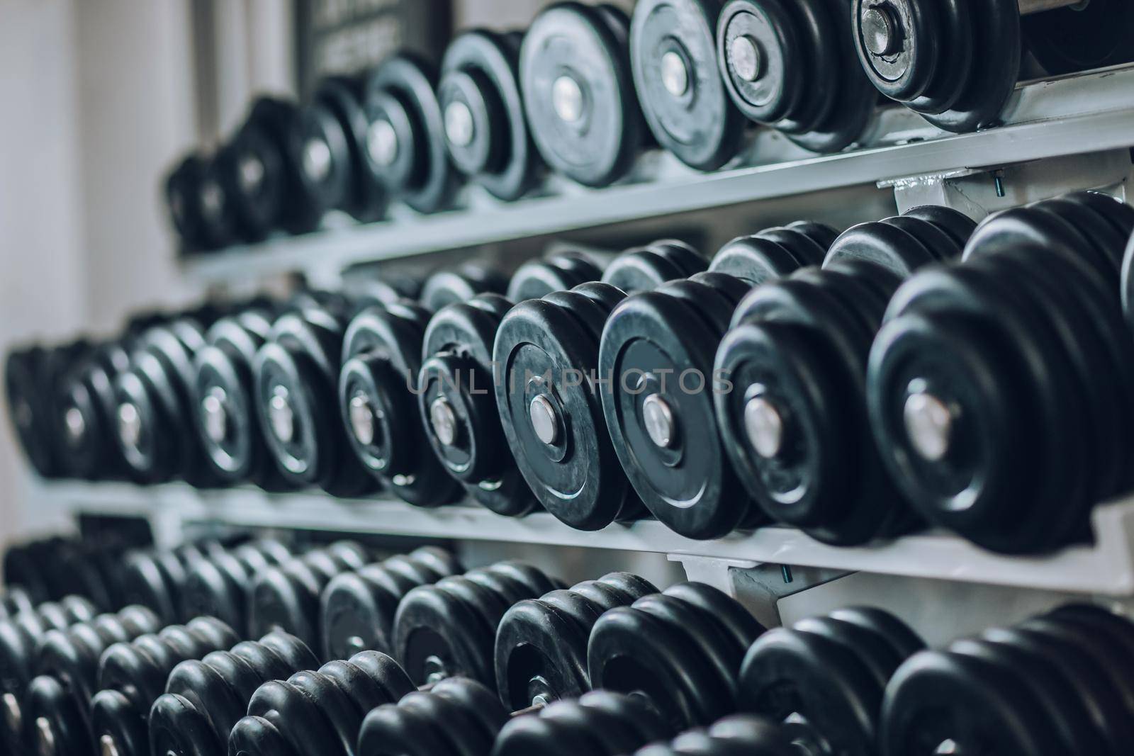 close up. the background image of rows of dumbbells in the gym
