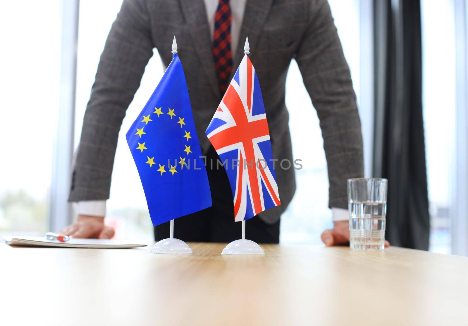 British flag and flag of European Union with businessman near by. Brexit by tsyhun