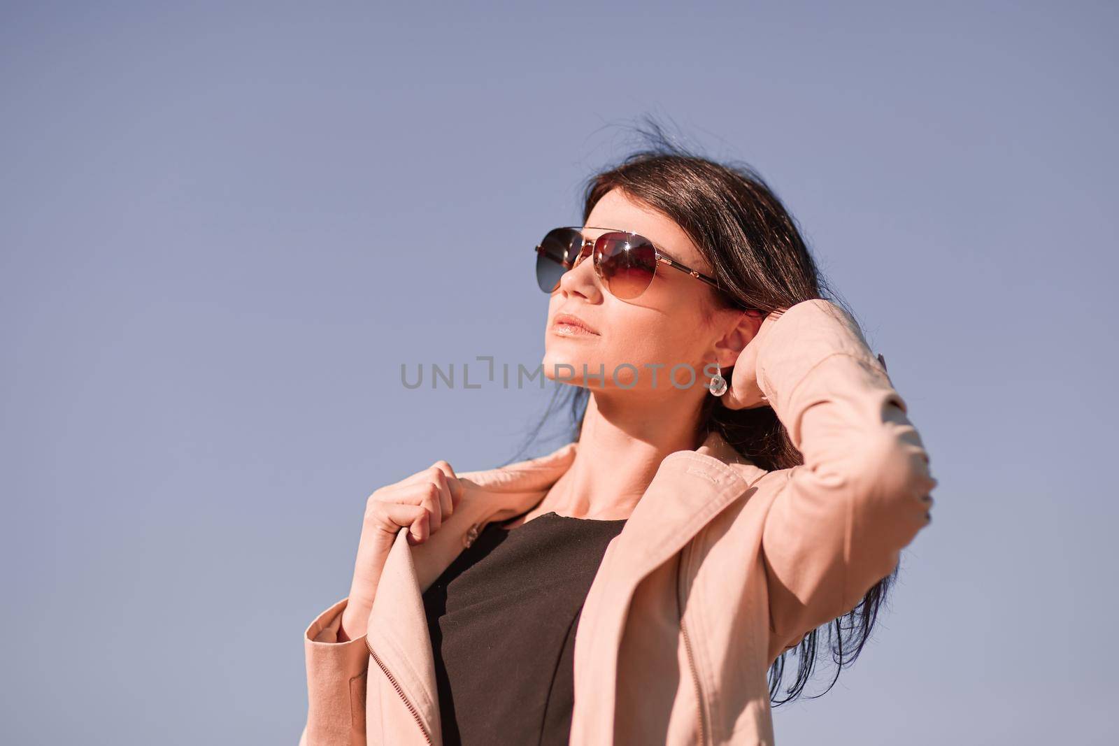 portrait of a young successful woman against the sky . photo with copy space