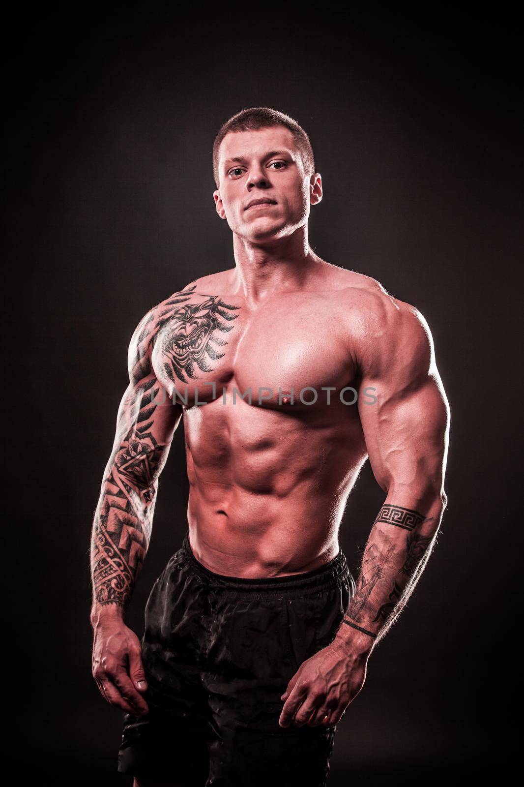 portrait of a handsome muscular male bodybuilder.isolated on black background