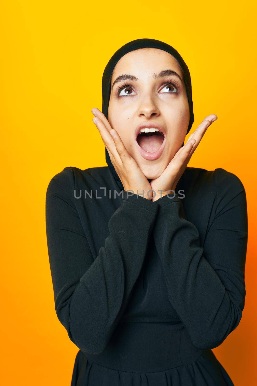 pretty woman in black hijab posing fashion hand gesture isolated background. High quality photo
