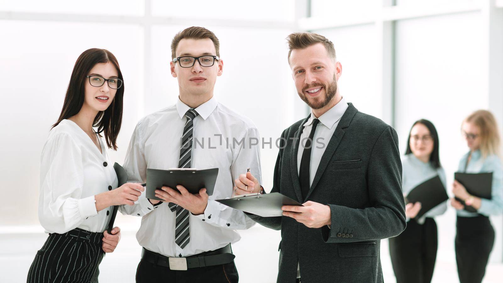 portrait of a successful business team standing in the office lobby.