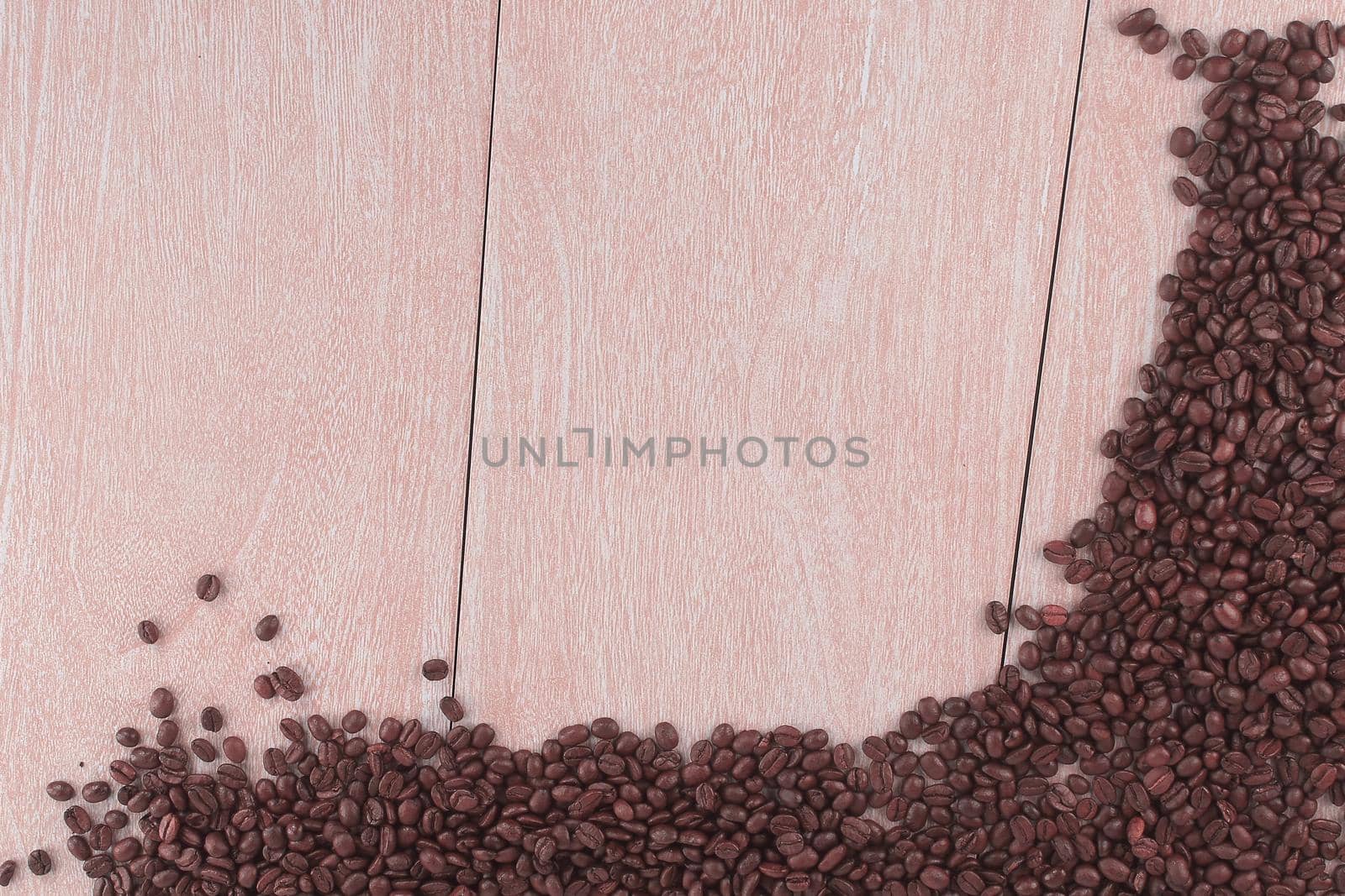 frame of roasted coffee beans on wooden background .photo with copy space.