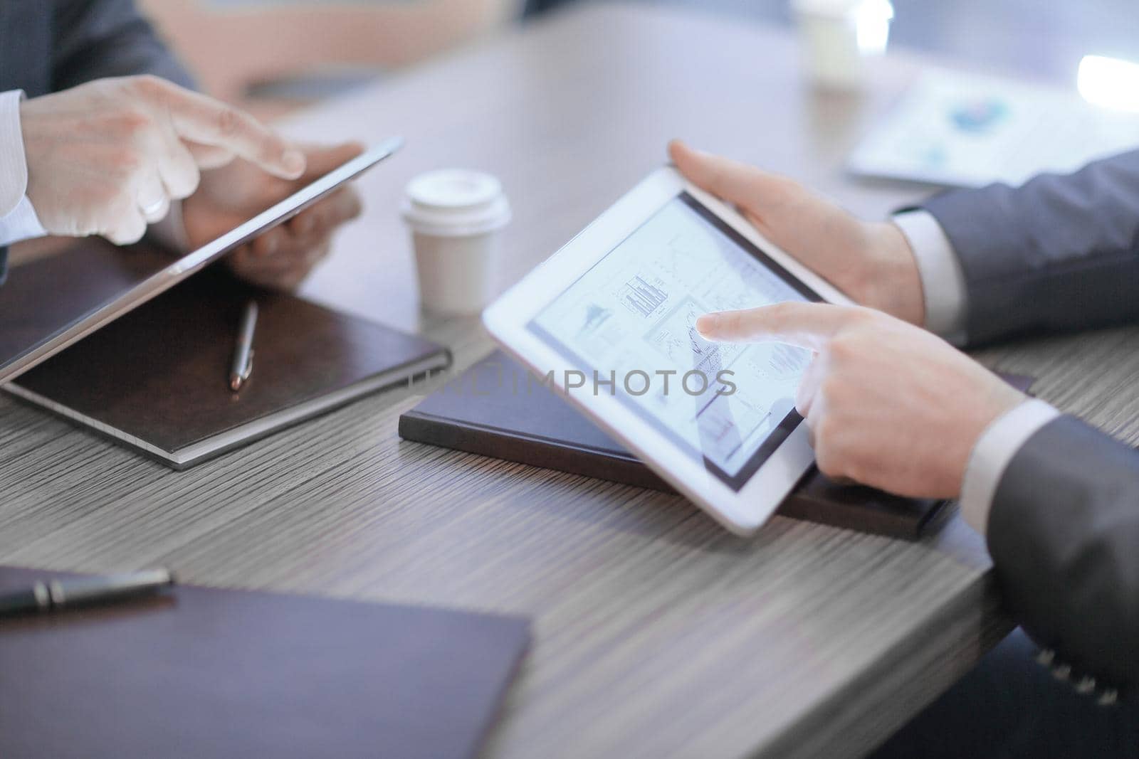 close up.two members constitute financial otches using digital tablet.