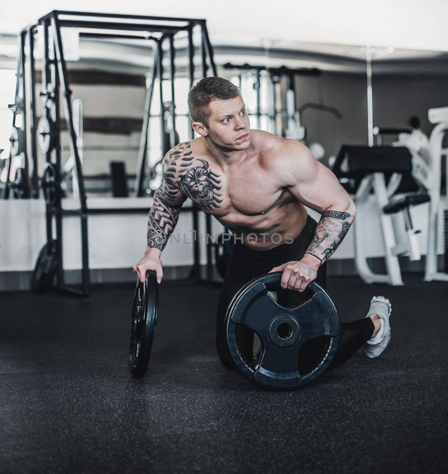 beautiful muscular man in training in the fitness room. strength and motivation