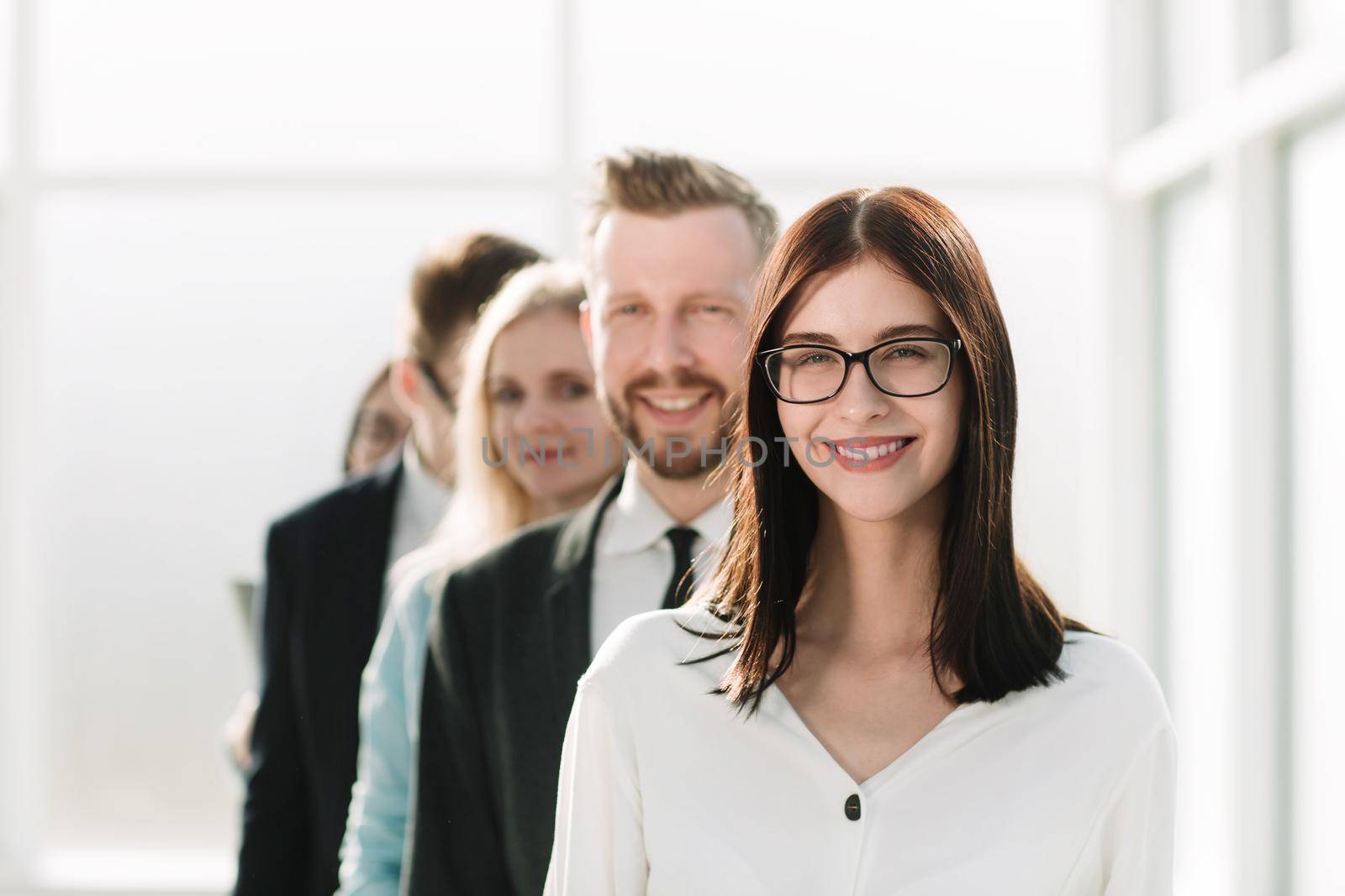 close up. young businesswoman standing in front of the business team. the concept of teamwork