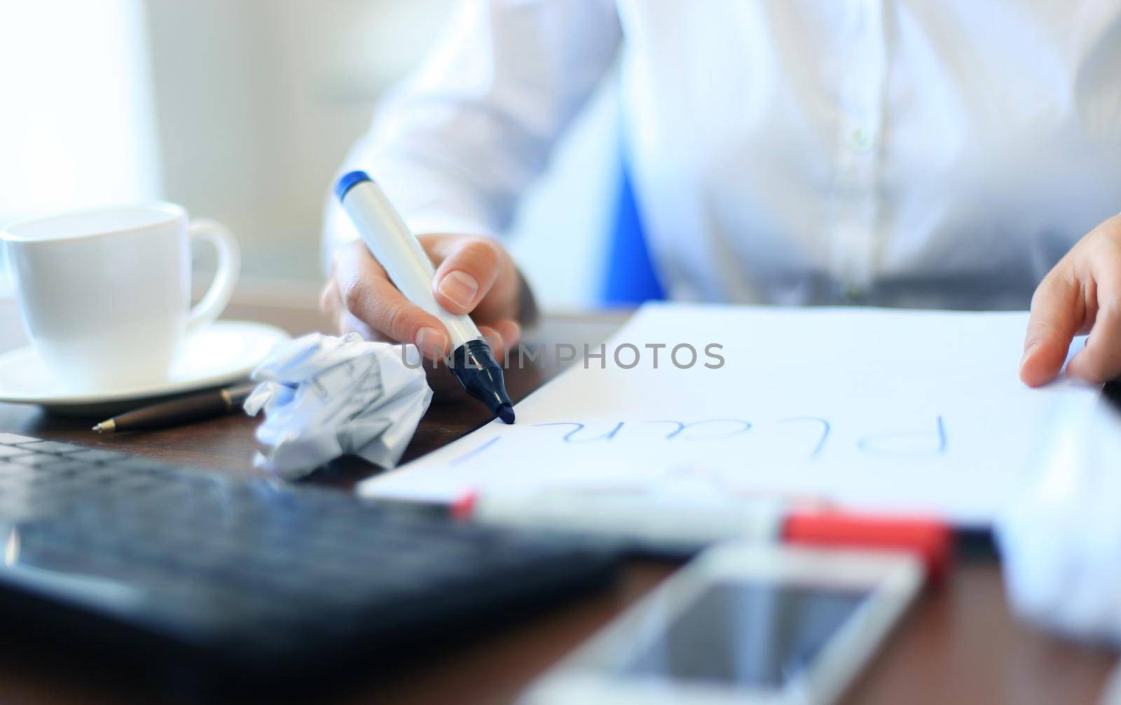 Business woman writing blank plan list by tsyhun