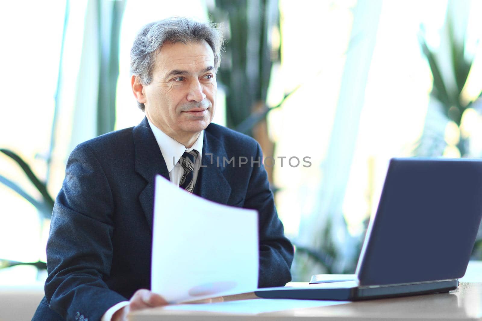businessman working with business documents sitting at his Desk. photo with copy space