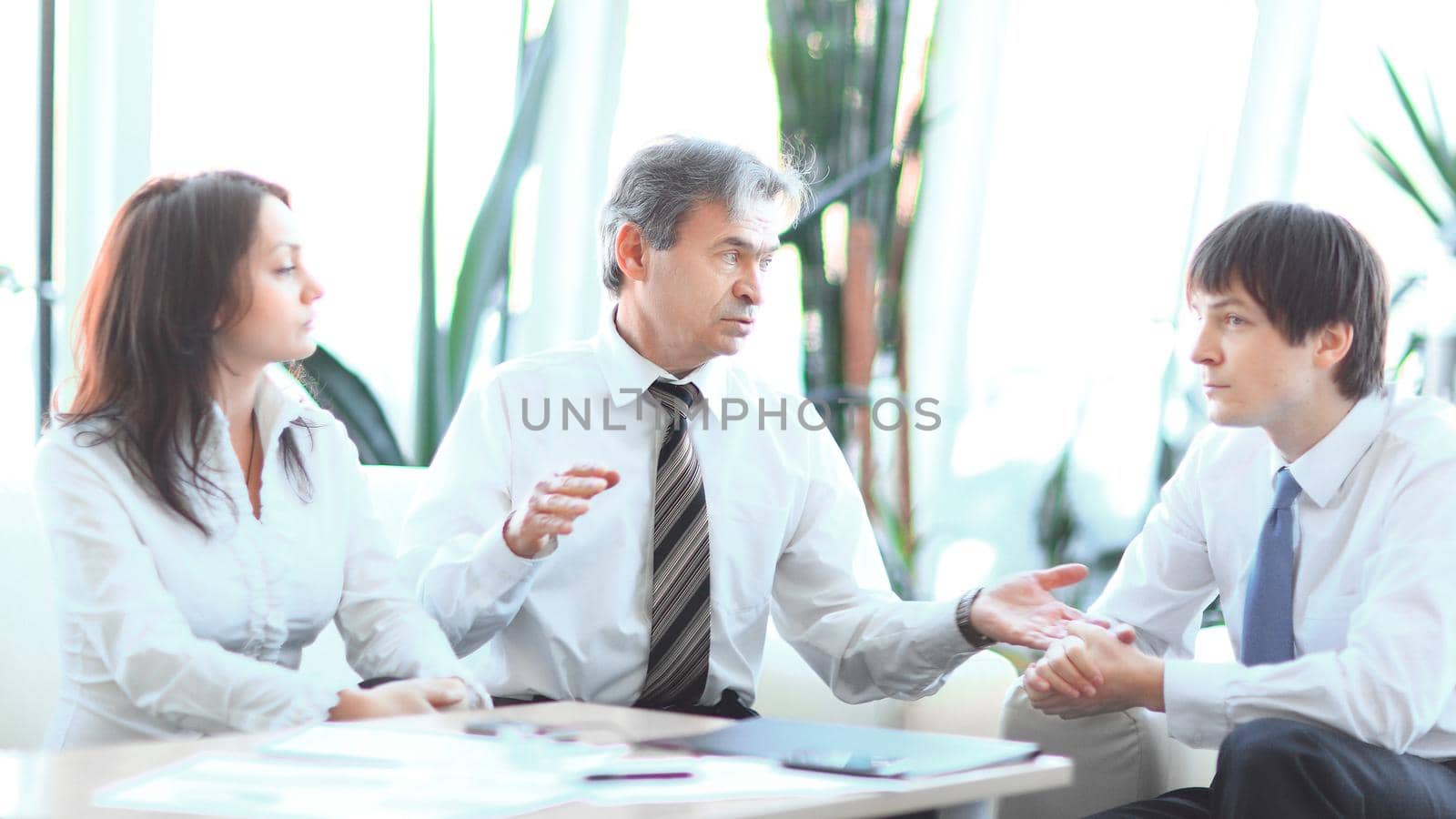project leader talking to business team in the workplace. by SmartPhotoLab