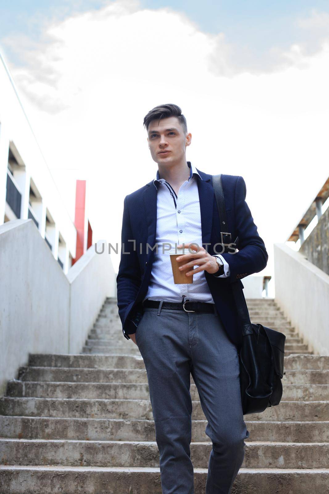 Businessman walking to work with coffee. Business success concept. by tsyhun