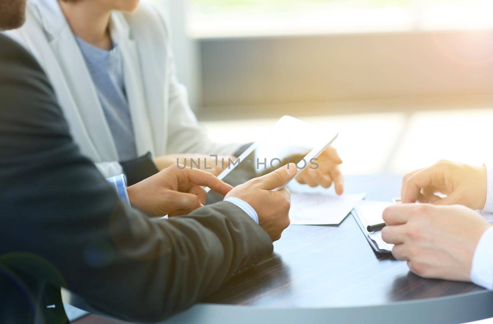 businessman hands touching digital tablet empty screen copy space, handshake during meeting.