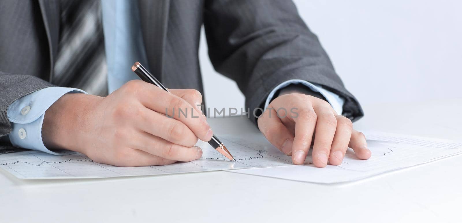 serious businessman working with documents sitting at a Desk. by SmartPhotoLab