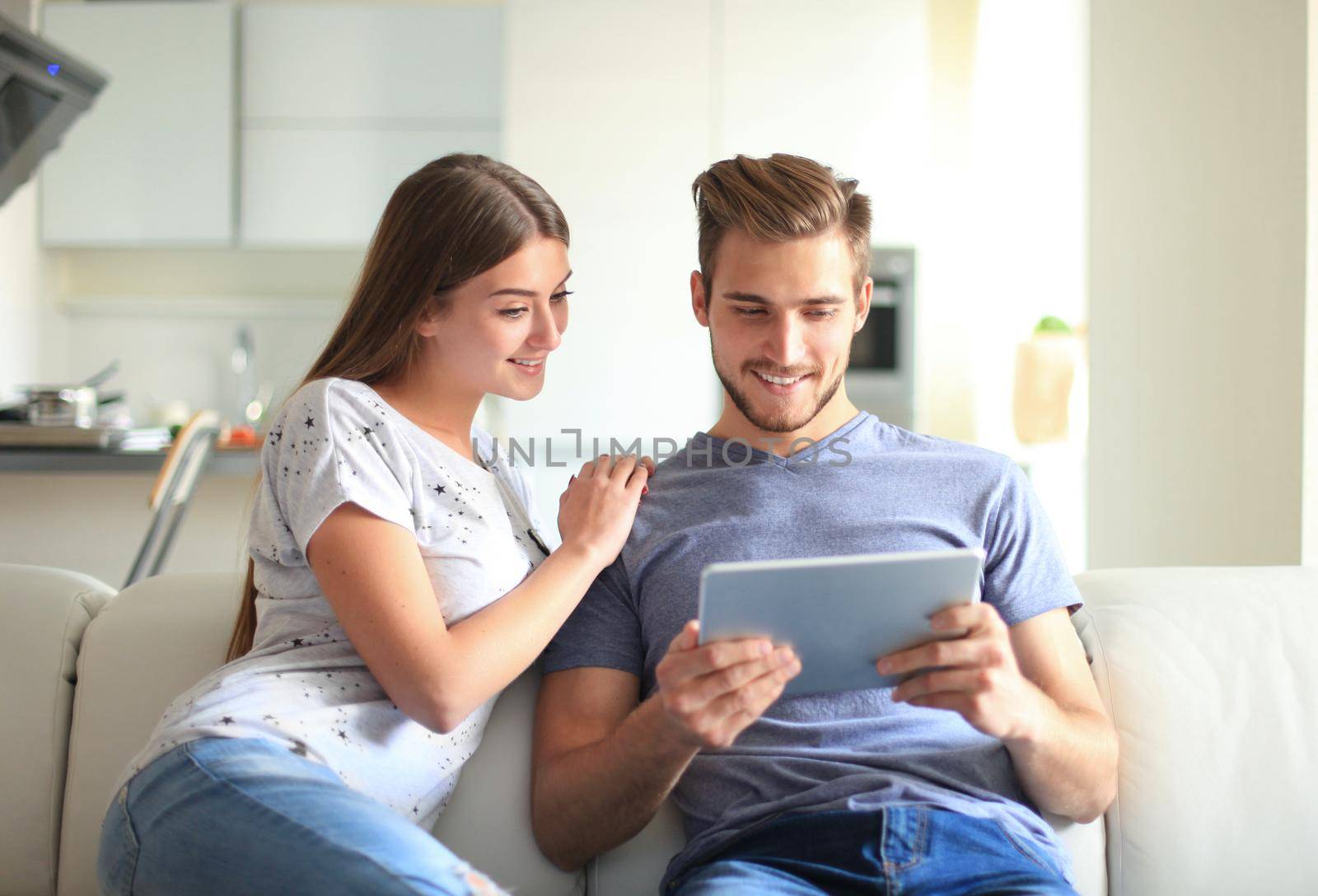 Happy couple in love surfing on tablet at home