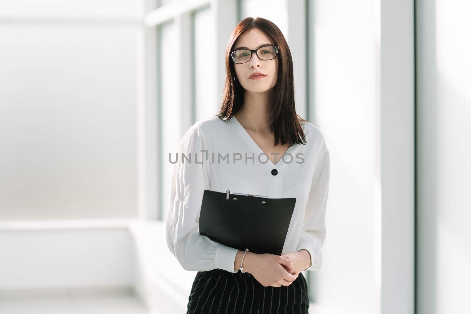 young businesswoman with standing in a bright office. photo with copy space