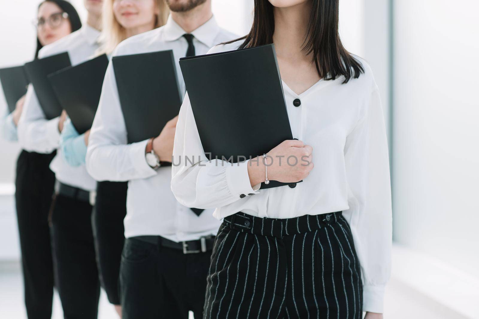 close up.young business people standing in a long line for an interview . the concept of career growth