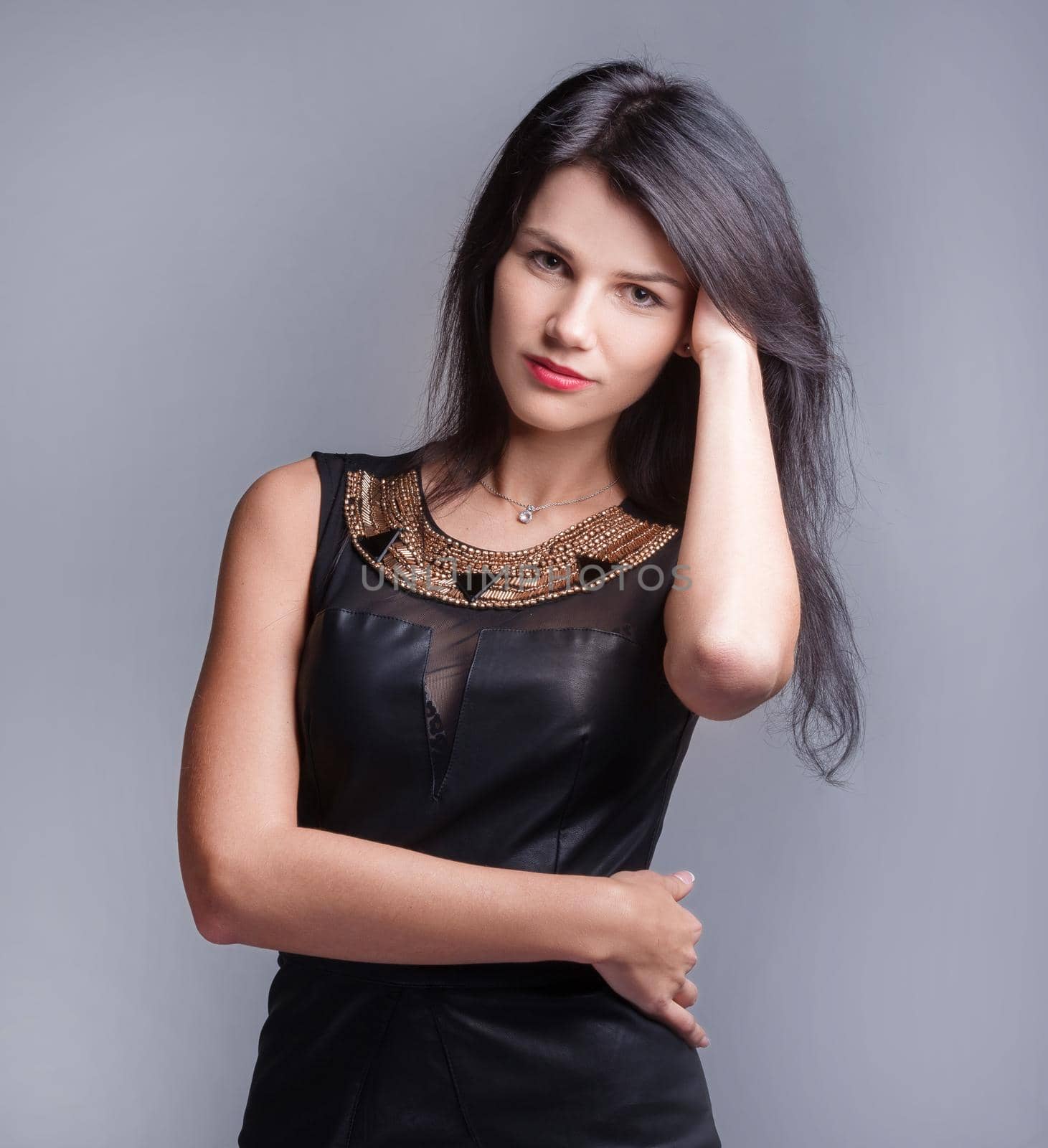 modern young woman in black dress . isolated on grey background