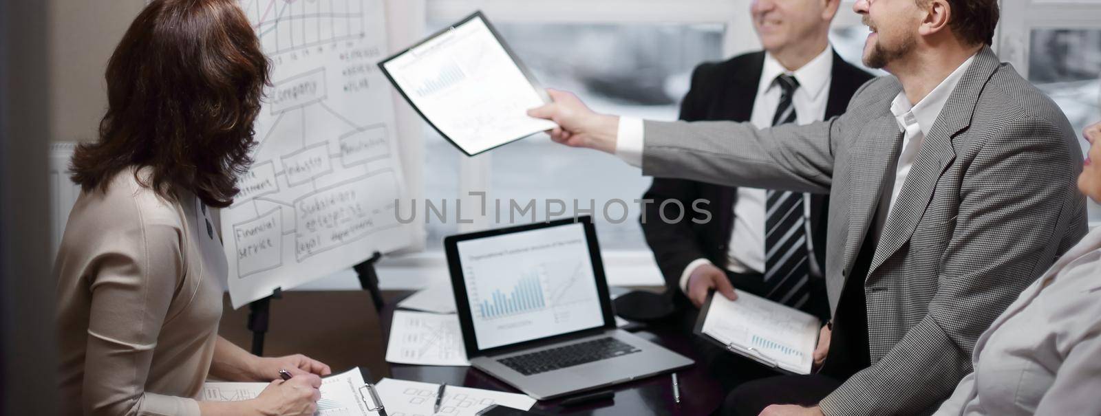 business team and investors discussing the company's profit in a modern office