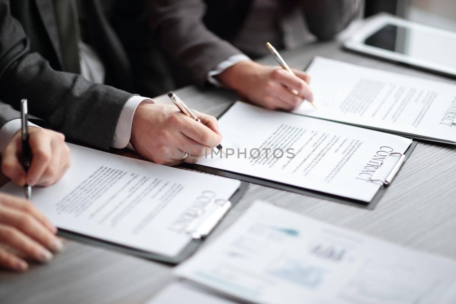 close up.business partners signing a new joint contract.