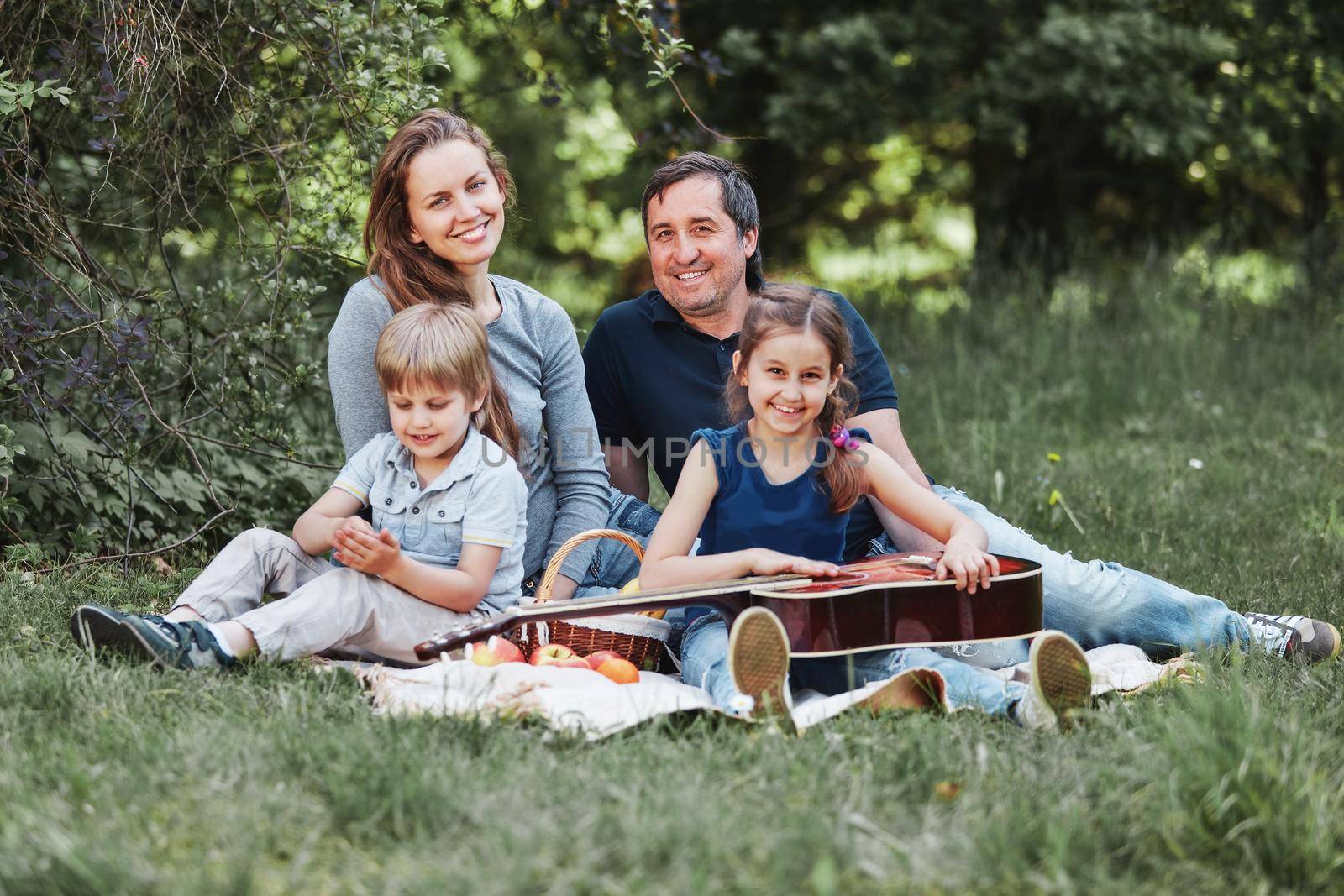 portrait of a family with two children on a picnic on Sunday