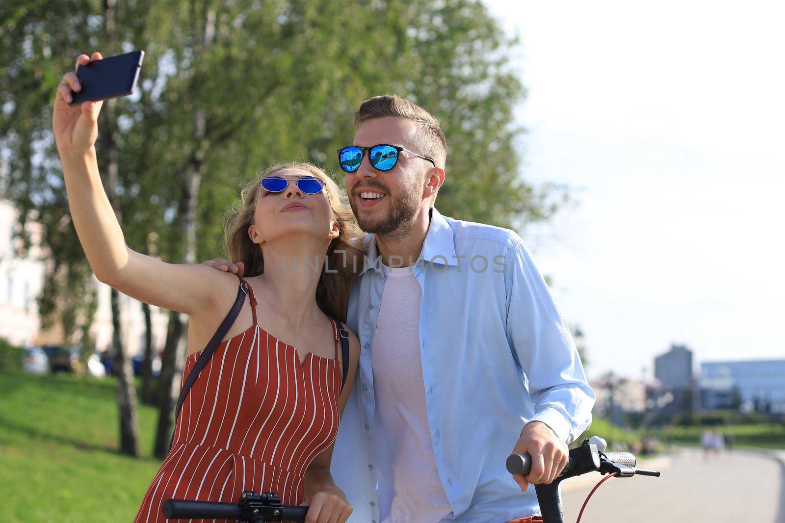 Loving cheerful happy couple taking selfie in the city by tsyhun