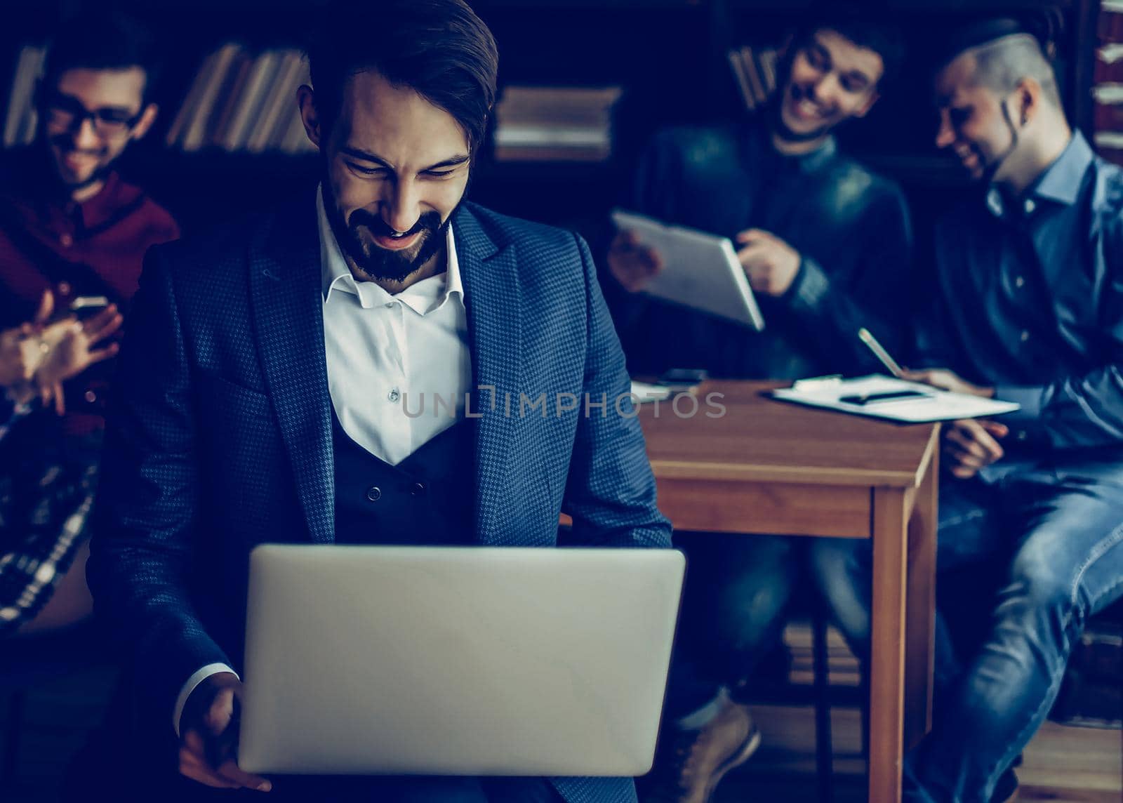 successful employee of the firm with a laptop and a business team discussing the current problems of the company