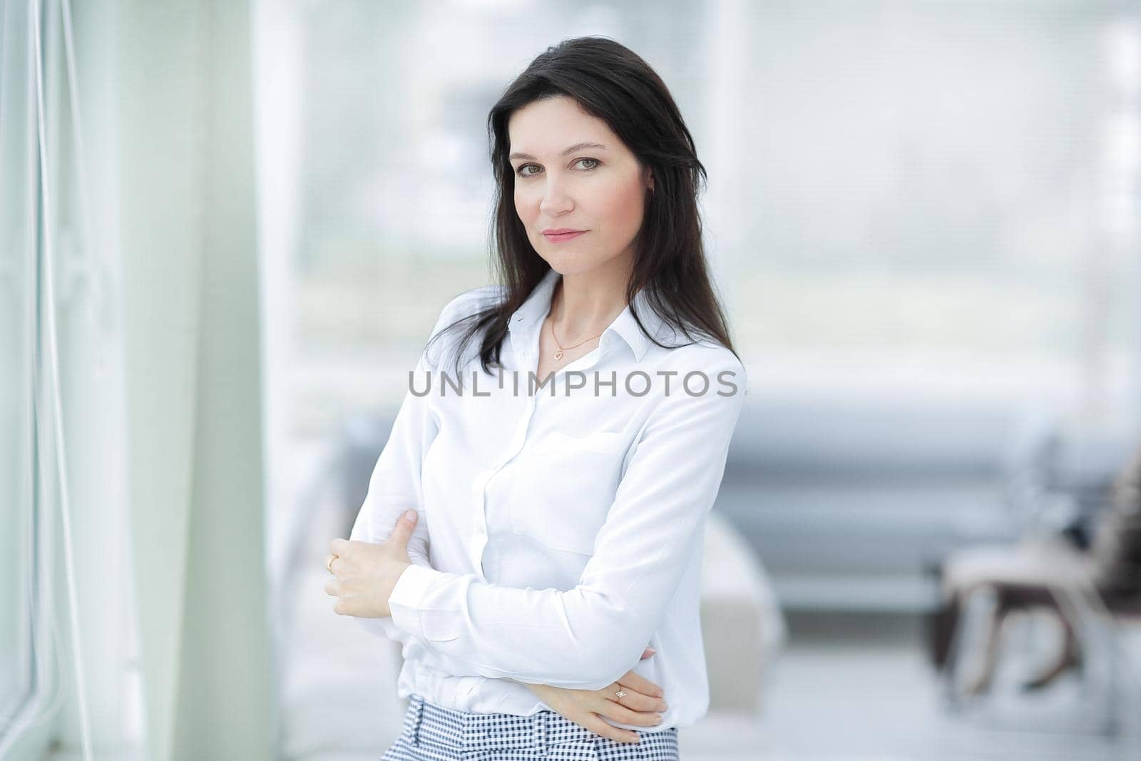 closeup.serious business woman standing near the window in the office.