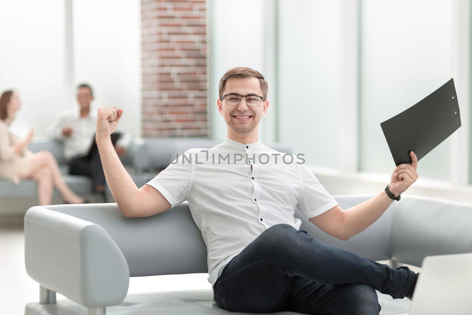 happy businessman sitting in the lobby of the Bank . business concept