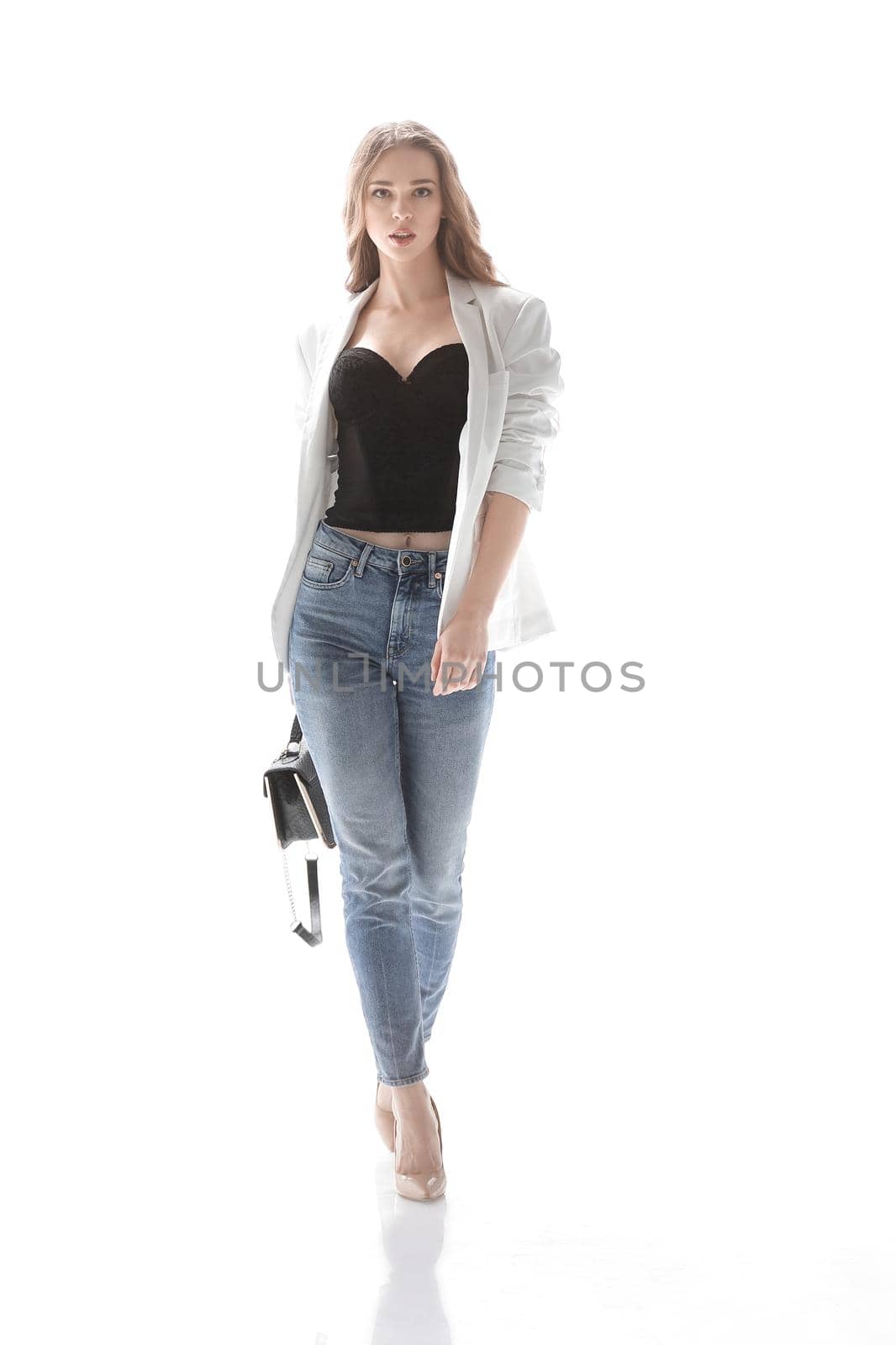 confident young woman with a graceful bag goes forward .isolated on white.photo with copy space.