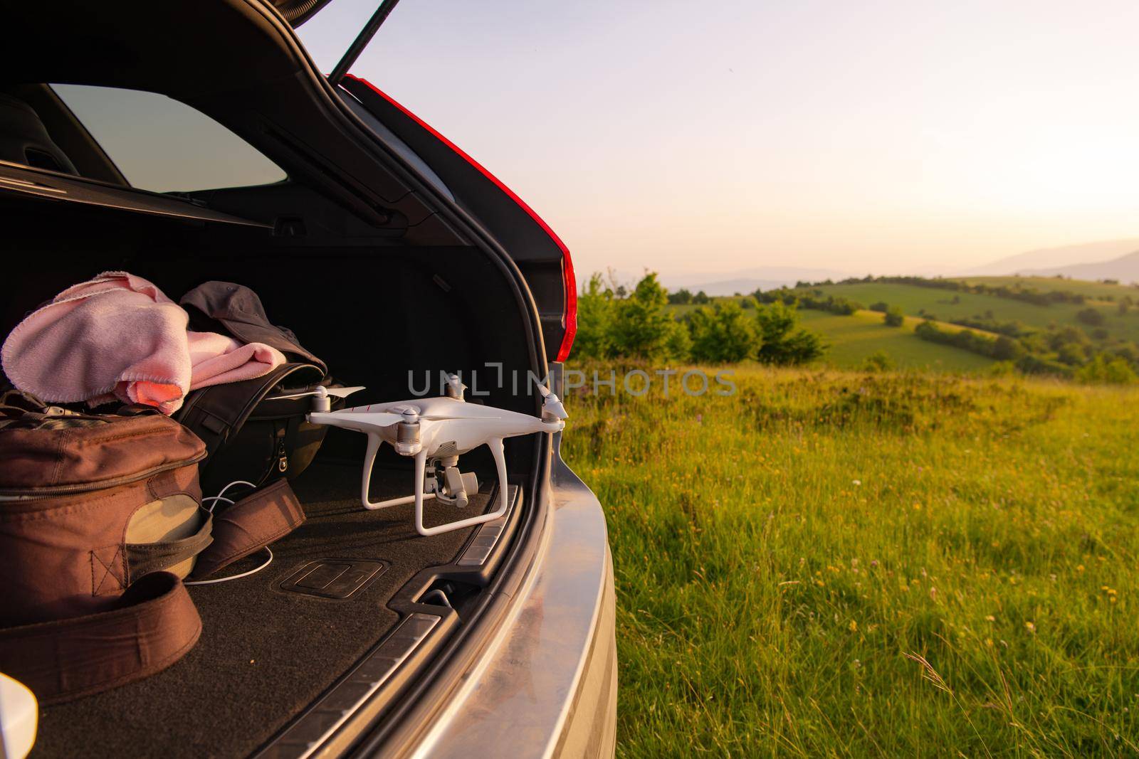 drone ready for fly in suv trunk landscape nature mountains sunset