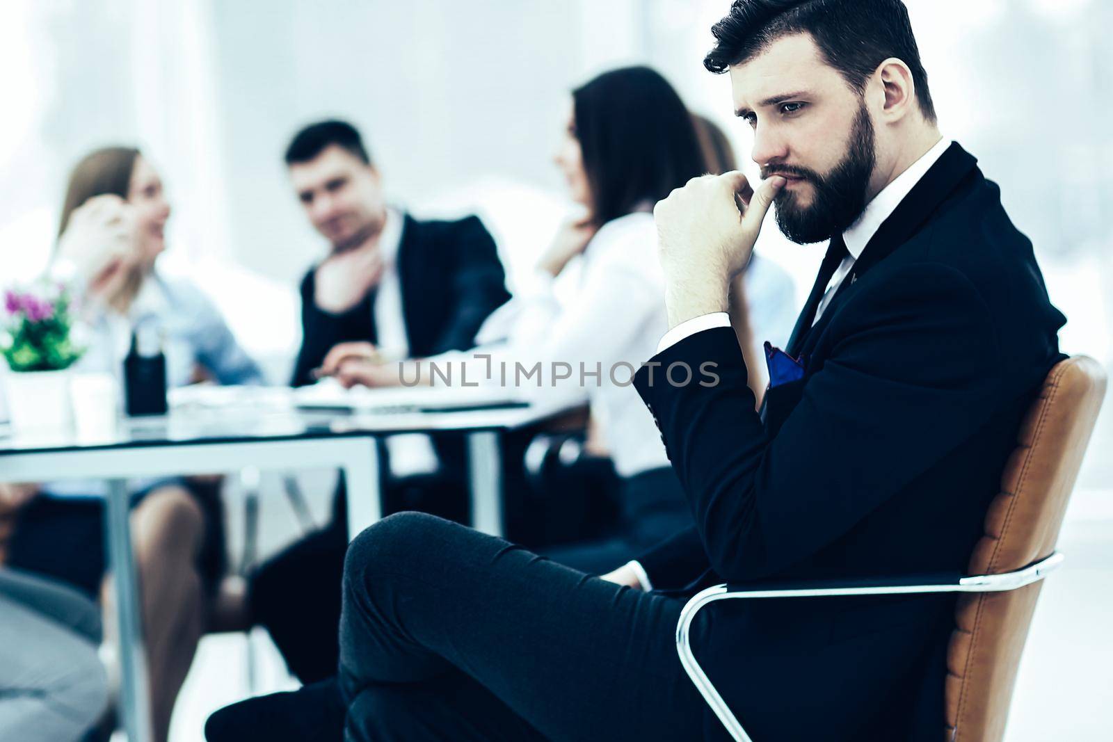financial Manager of the company on the background of the working meeting the business team.the photo has a empty space for your text