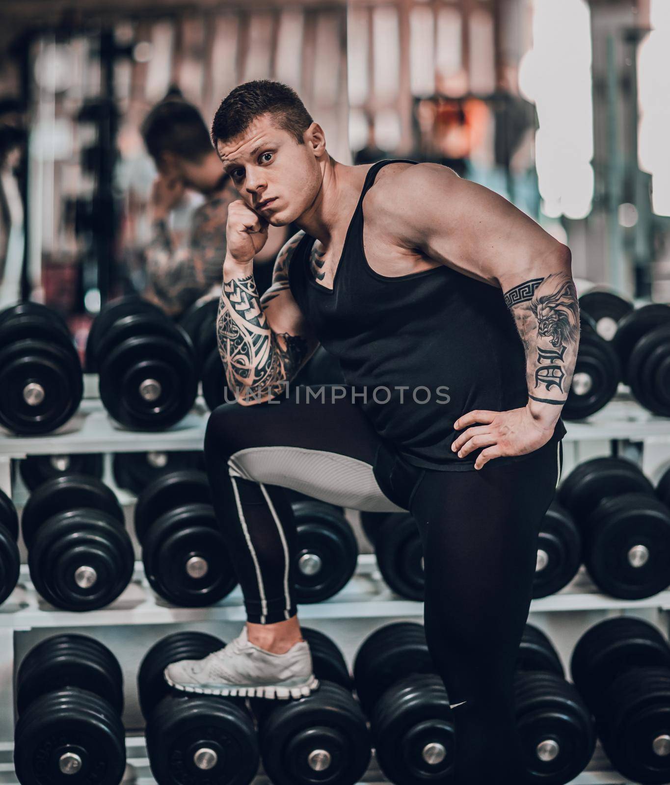 purposeful muscular guy standing in the gym. photo with copy space