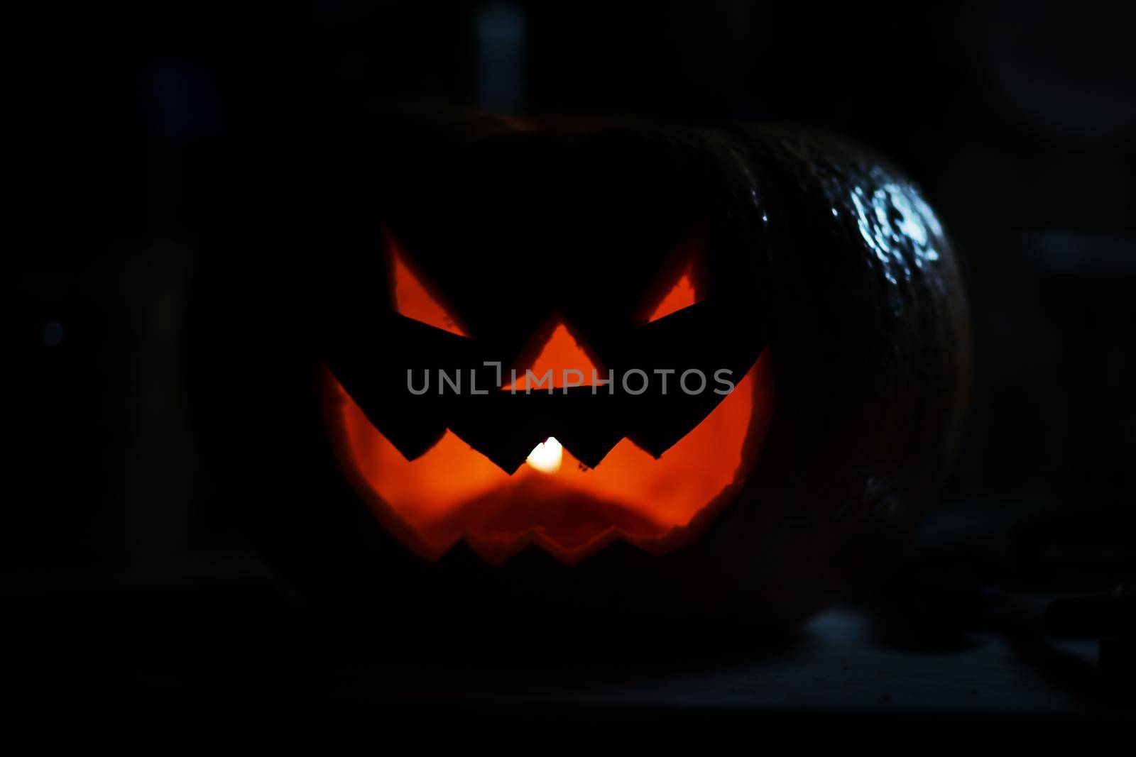 creepy smiling pumpkin for Halloween on black background.photo with copy space