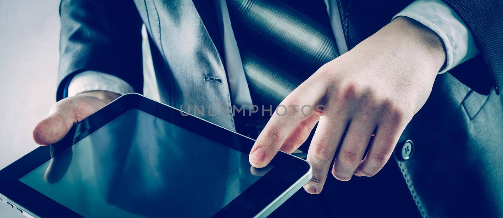 closeup of businessman with digital tablet on light background.