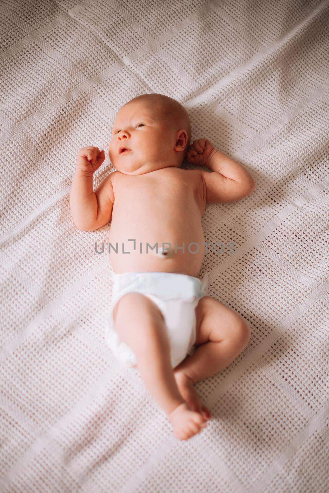 pretty newborn baby boy in a diaper . photo with space for text