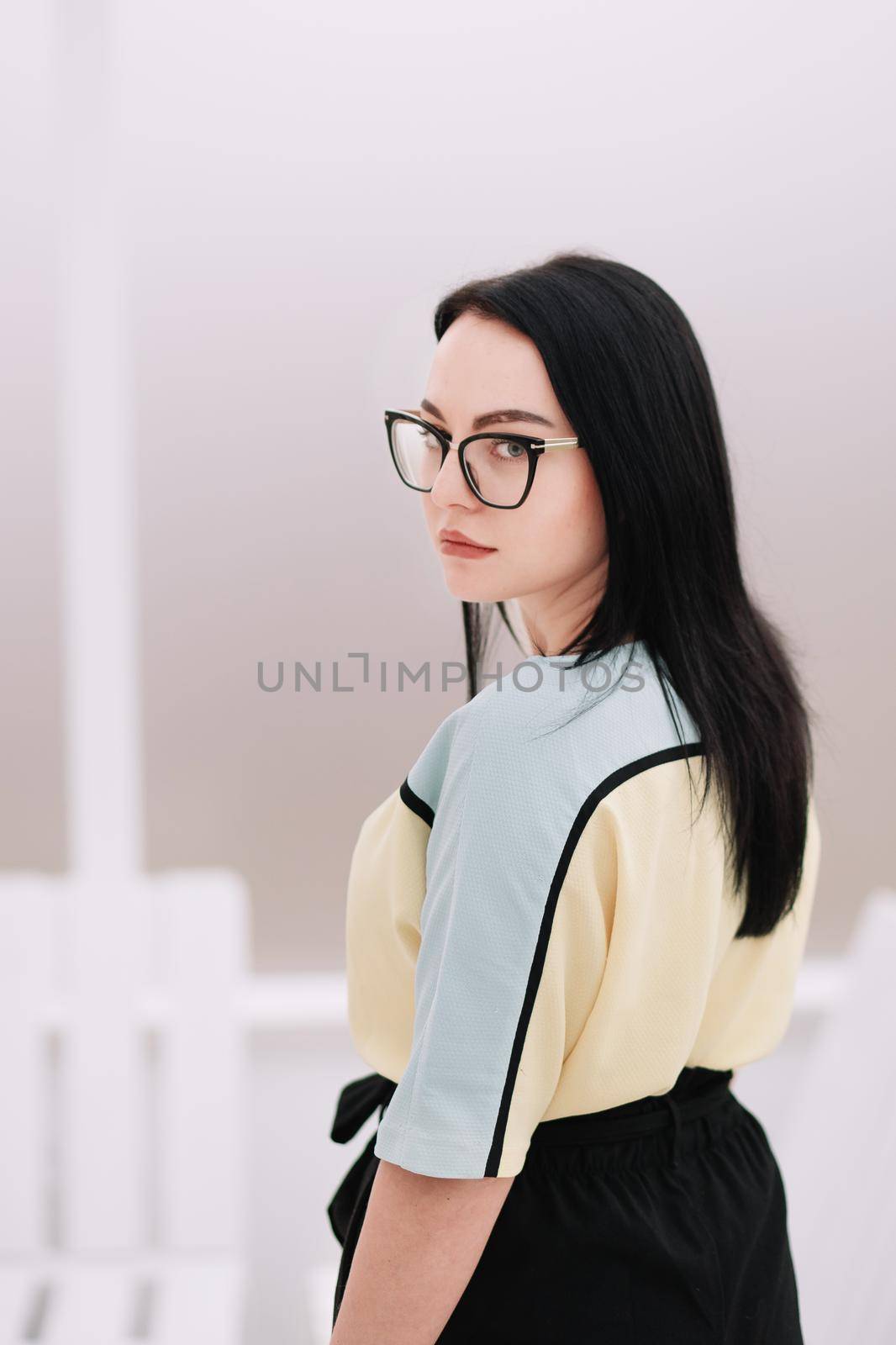 side view. business woman with glasses looking at camera. isolated on white.