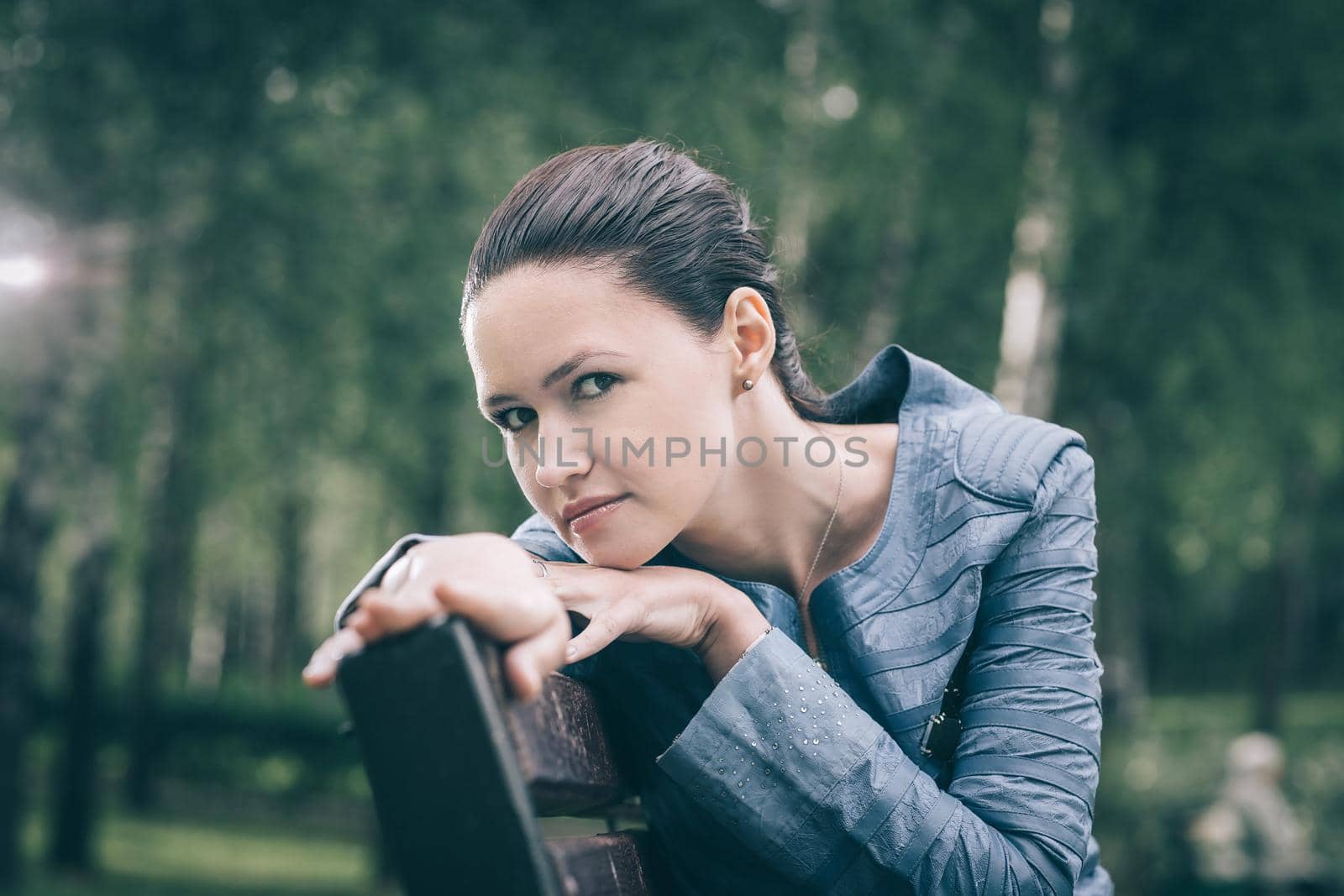 close up. cute young woman sitting on a Park bench