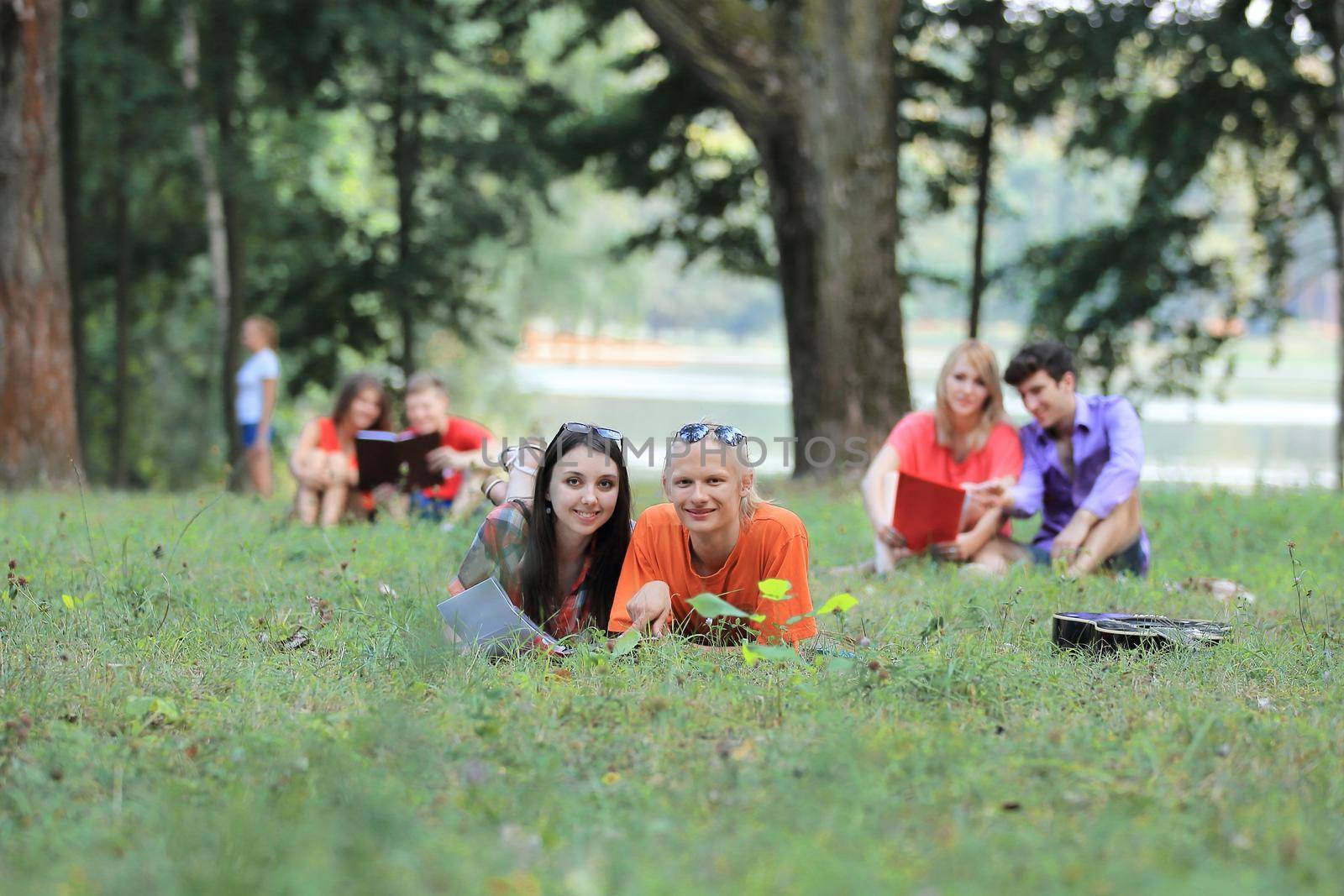 group of student couples preparing for exams in the city Park.